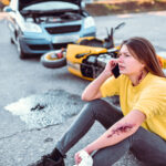 Car Accident Aftermath - Female Calling Emergency Services